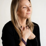 Rebekah wearing the Amethyst bracelets as a bracelet stack. The Evoline Amethyst Calm & Clarity Bracelet, purple gemstone bracelet for calm and clarity, energy bracelet