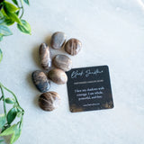 the evoline black sunstone tumbled stone with affrimation card