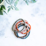 The Evoline Shine Your Light (Success) 5-Bracelet Stack: Sunstone, Tiger’s Eye, Pyrite, Carnelian & Ruby in Kyanite