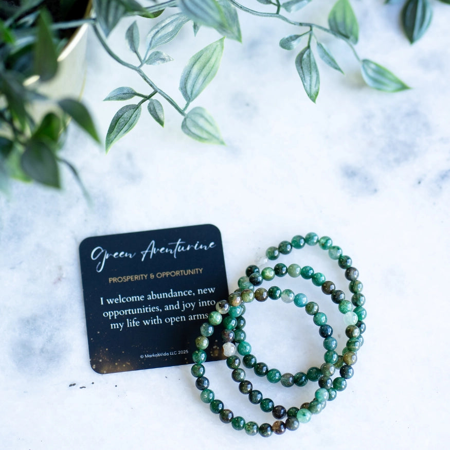The Evoline Green Aventurine Prosperity and Opportunity Bracelet shown with meaning card and stacked bracelets.