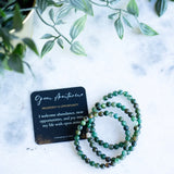 The Evoline Green Aventurine Prosperity and Opportunity Bracelet shown with meaning card and stacked bracelets.