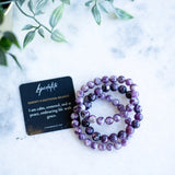 The Evoline Lepidolite Serenity & Emotional Balance Bracelet with meaning and affirmation card.