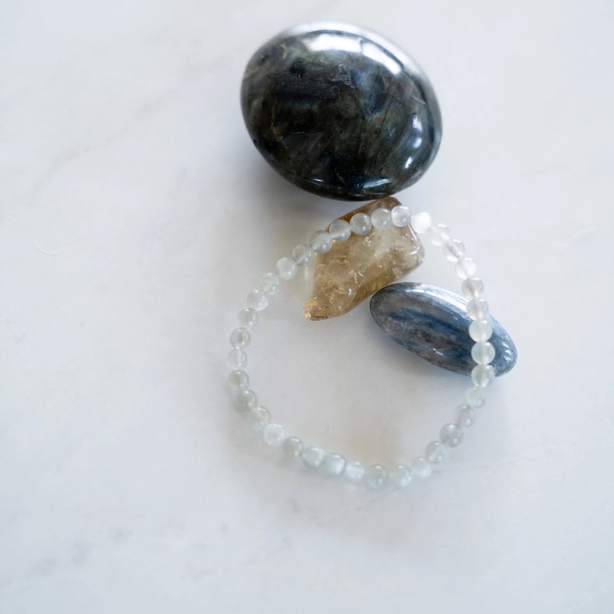 The Evoline Moonstone Bracelet shown on natural stones.