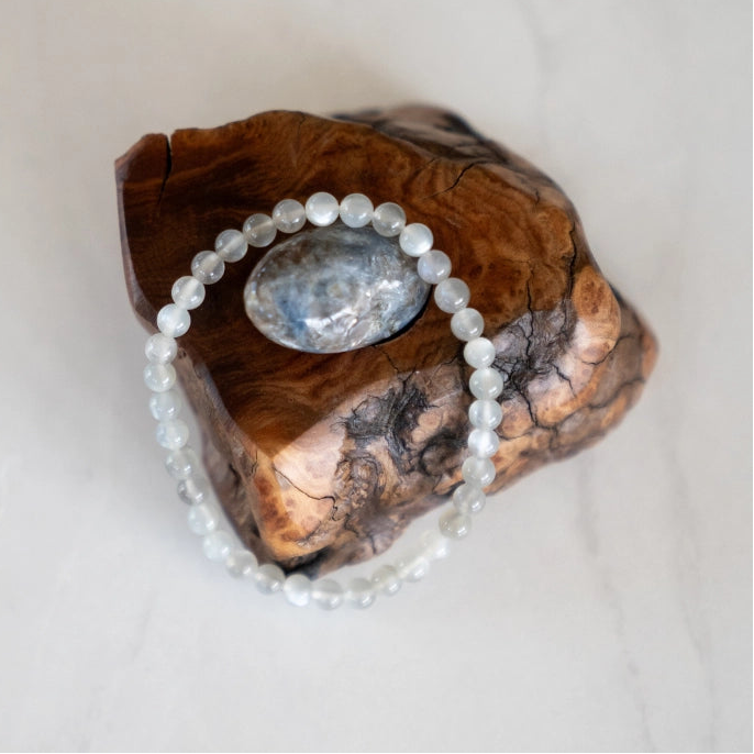 The Evoline Moonstone Bracelet shown on natural elements.