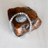 The Evoline Moonstone Bracelet shown on natural elements.
