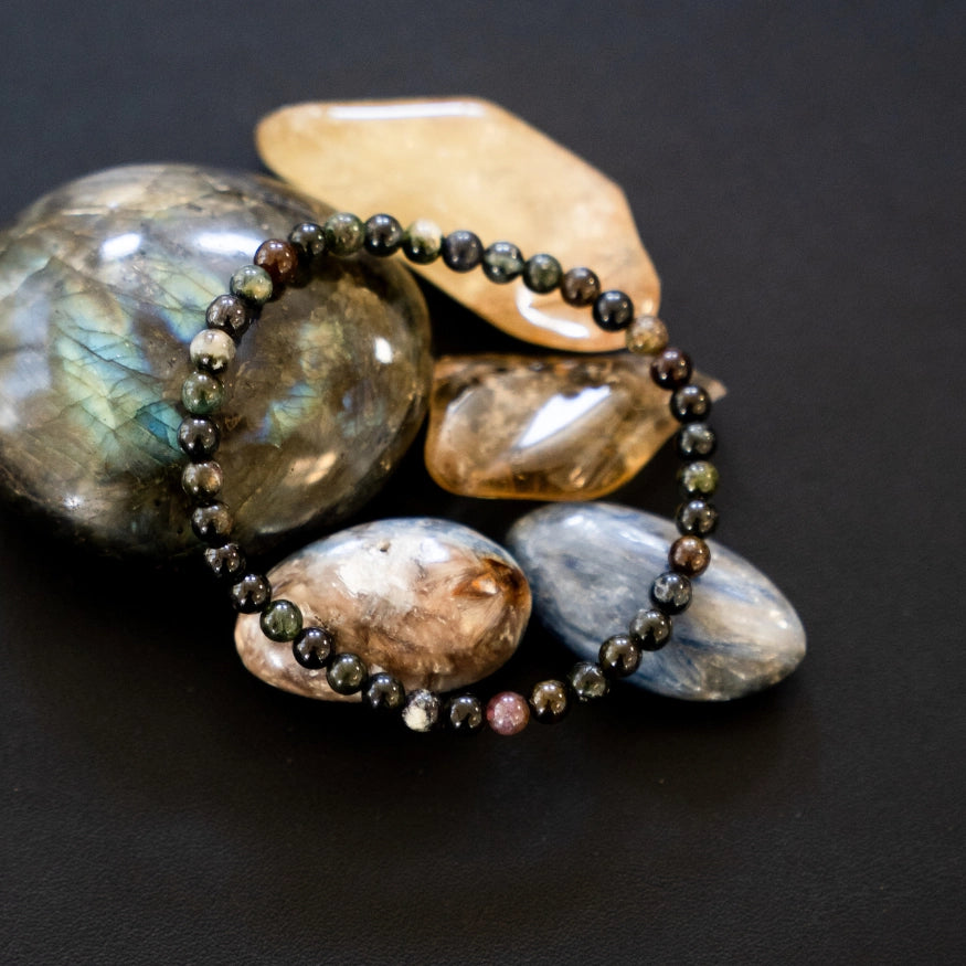 The Evoline Multi-Colored Tourmaline Bracelet shown on natural elements.