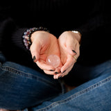 The Evoline Star Rose Quartz Unconditional Love & Inner Radiance Sphere held in open palms.