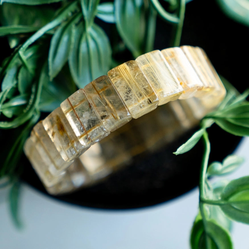 Gold Rutilated Quartz Bracelet on natural background
