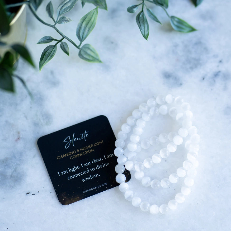 The Evoline Selenite Cleansing & Higher Light Connection Bracelet stacked with affirmation card.