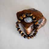 The Evoline Tigers Eye Courage and Clarity Bracelet on natural elements.