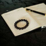 Garnet Bracelet from The Evoline on a journal during reflection.