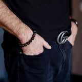 Male wearing a Garnet Bracelet from The Evoline