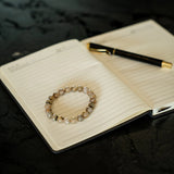 Rutiliated Quartz bracelet on a journal during reflection