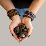 The Evoline Manifesting Trio: Labradorite, Blue Kyanite in Quartz & Citrine held in her hands.